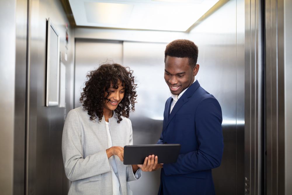 Man and woman talking in an elevator