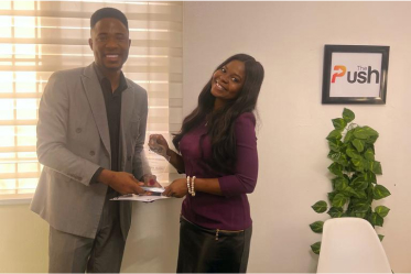Aderinsola Jolaosho receiving a certificate of appreciation from Ace Real Estate 
